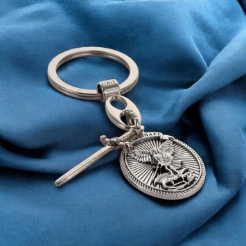 Porte cles en metal forme ovale avec St Michel entouré de rayons accompagné d'une épée en breloque H 3 cm