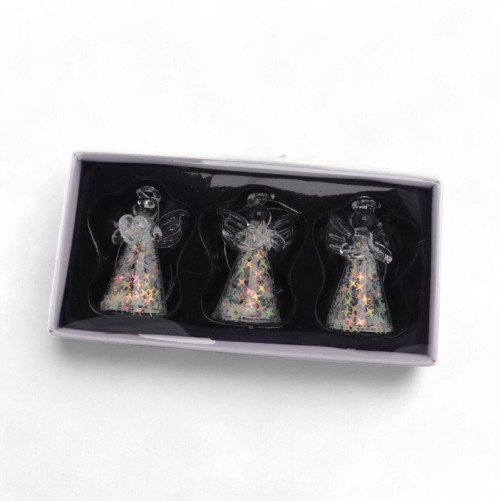 Ange en verre transparent, robe pailletée décorée d’étoiles irisées. H. 4,5 cm. Série de 3 modèles assortis.