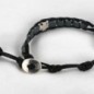 Bracelet dizainier ajustable sur corde de couleur noire avec grains carrés en hématite et croix en métal..