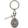 Porte cles en metal forme ovale avec St Michel entouré de rayons accompagné d'une épée en breloque H 3 cm