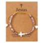 Bracelet sur corde réglable grains de forme cylindrique avec croix et coeur en coquille naturelle.