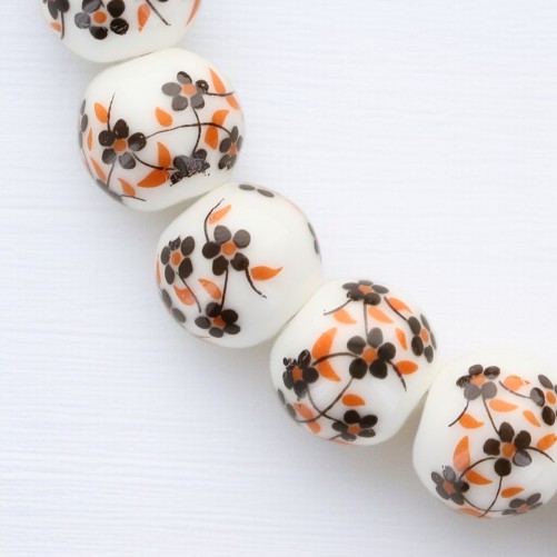 Bracelet sur élastique grains porcelaine Ø 1 cm. Fleur Orange