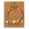 Bracelet sur corde réglable grains de forme cylindrique avec croix et coeur en coquille naturelle.