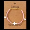 Bracelet sur corde réglable grains de forme cylindrique avec croix et coeur en coquille naturelle.