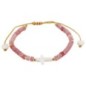 Bracelet sur corde réglable grains de forme cylindrique avec croix et coeur en coquille naturelle.
