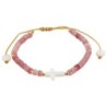 Bracelet sur corde réglable grains de forme cylindrique avec croix et coeur en coquille naturelle.